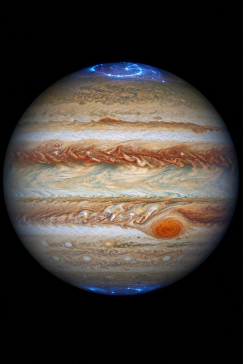 Planet jupiter space astronomy cosmos universe atmosphere storm weather clouds bands belts vortex aurora brightness darkness exploration gas giant out stunning view of Jupiter, the largest planet in our solar system. The planet's surface is a mix of swirling clouds and bands of different colors, including shades of brown, orange, and white. The most prominent feature is a large, circular storm known as the Great Red Spot, which is located in the southern hemisphere. The storm is surrounded by a series of smaller storms and clouds, creating a dynamic and ever-changing atmosphere. The image also shows the planet's poles, which are illuminated by the sun's light, creating a bright and vibrant effect. Overall, the image captures the beauty and complexity of Jupiter's atmosphere, showcasing the planet's unique and fascinating features.