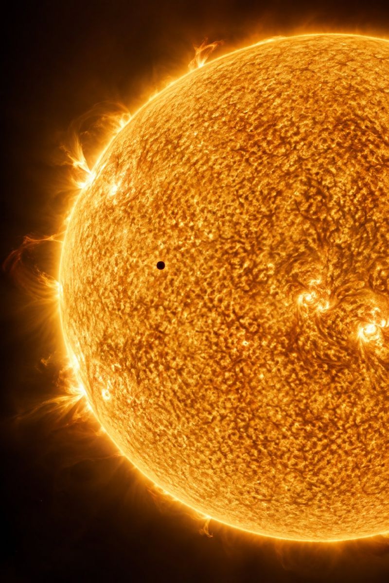 Sun solar star astronomy space cosmos universe celestial brightness heat energy radiation atmosphere surface flare corona photosphere chromosphere gra close-up view of the Sun, captured in high resolution. The Sun's surface is a vibrant golden-orange color, with a textured appearance resembling a swirling, fiery ocean. The surface is dotted with numerous small, dark spots, which are sunspots. These sunspots vary in size and shape, creating a complex and dynamic pattern. The Sun's outer edge is slightly blurred, with a faint, glowing halo that fades into the dark background. The overall effect is one of intense heat and energy, with the Sun's powerful radiation and magnetic fields subtly influencing the surrounding space.