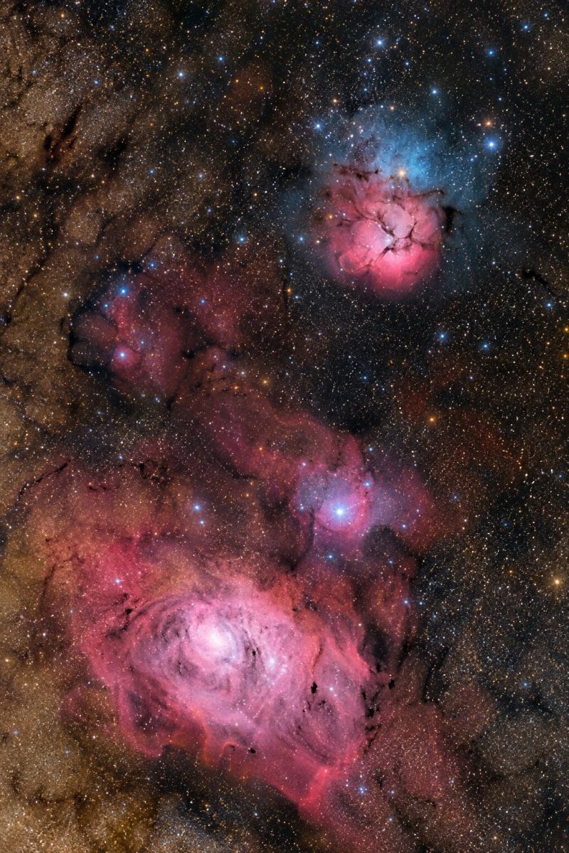 Nebuleuse etoile espace astronomie galaxie univers cosmos celeste nuit ciel amas L'image présente une vue captivante du ciel nocturne, dominé par des nébuleuses et des étoiles vibrantes. Au centre se trouve une nébuleuse proéminente d'une teinte rose saisissante, avec des motifs complexes et tourbillonnants qui ressemblent à une rose ou à une fleur. À droite de cette nébuleuse centrale, se trouve une autre nébuleuse de forme plus irrégulière, émettant un mélange de couleurs rose et bleu. Le fond est d'un bleu foncé profond, parsemé de nombreuses étoiles de tailles et de luminosités variables. L'ensemble de la scène est empreint d'un sentiment d'émerveillement cosmique, mettant en valeur la beauté et la complexité de l'univers.